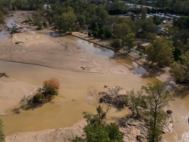 Water is seen outside the banks of the Swannanoa river in the aftermath of Hurricane Helene, Tuesday, Oct. 1, 2024, in Swannanoa, N.C. (AP Photo/Mike Stewart)