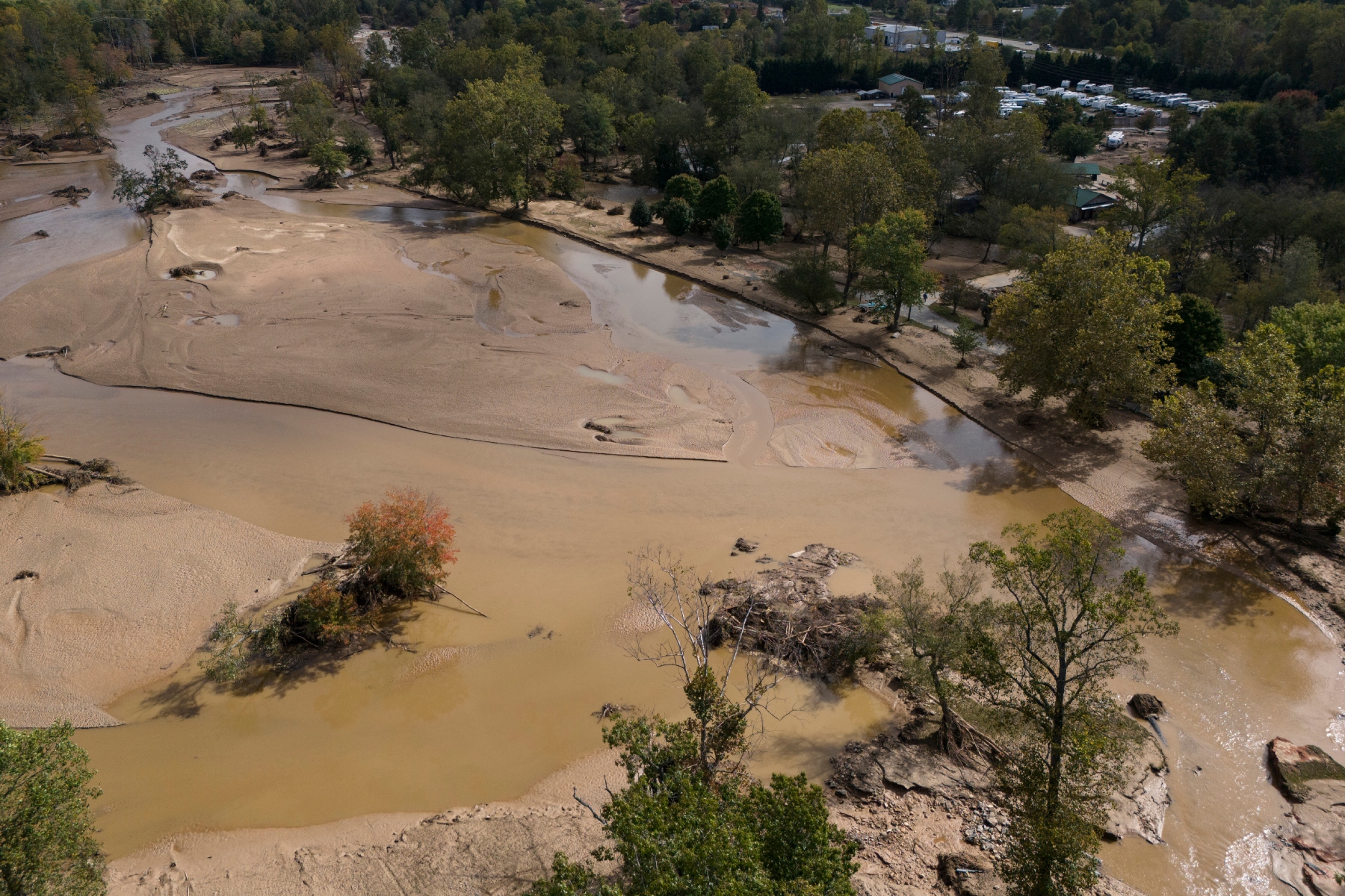 Water is seen outside the banks of the Swannanoa river in the aftermath of Hurricane Helene, Tuesday, Oct. 1, 2024, in Swannanoa, N.C. (AP Photo/Mike Stewart)