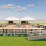 Two white event tents sit behind rows of wooden bleachers on a grassy field under a blue sky with scattered clouds, at a sports venue.