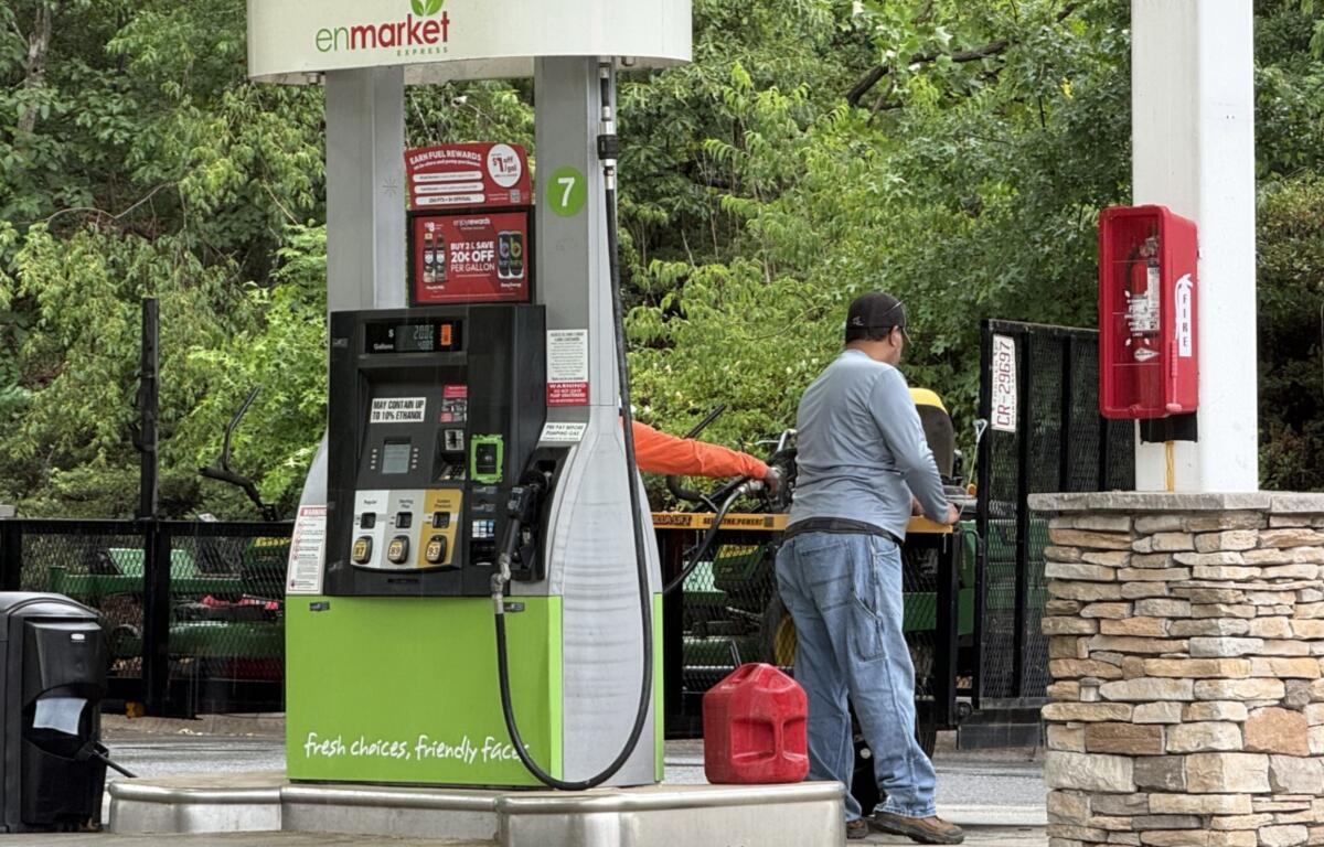 A driver fills up at a local gas station in Asheville as fuel prices remain above $4 a gallon, prompting many motorists to rely on rewards programs and price comparisons to save money at the pump.