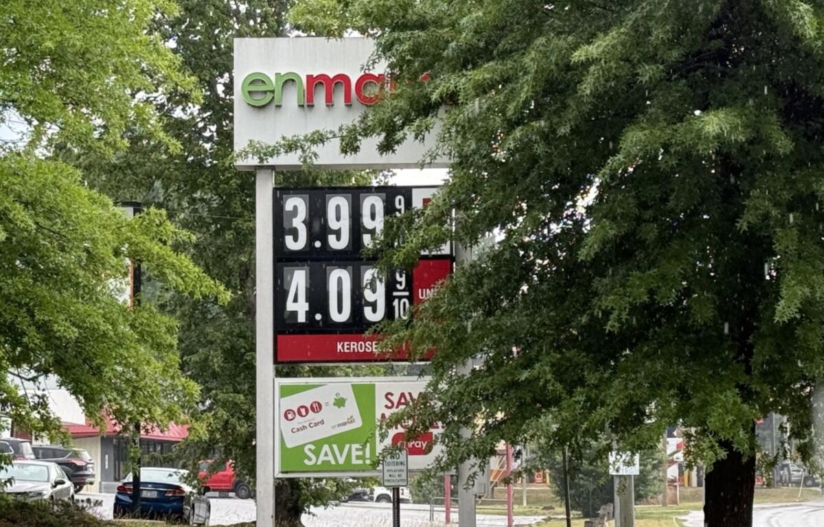 A driver fills up at a local gas station in Asheville as fuel prices remain above $4 a gallon, prompting many motorists to rely on rewards programs and price comparisons to save money at the pump.
