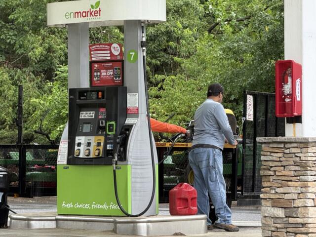 A driver fills up at a local gas station in Asheville as fuel prices remain above $4 a gallon, prompting many motorists to rely on rewards programs and price comparisons to save money at the pump.