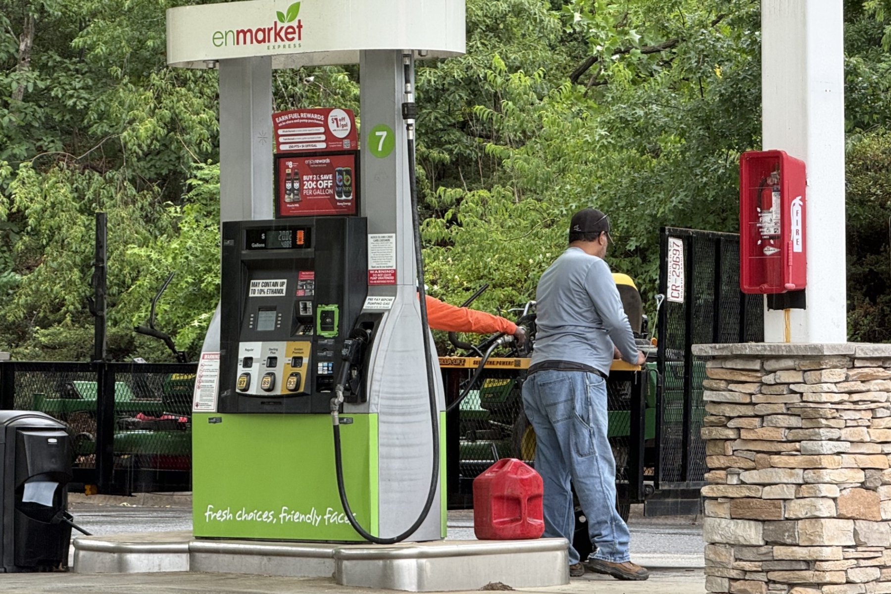 A driver fills up at a local gas station in Asheville as fuel prices remain above $4 a gallon, prompting many motorists to rely on rewards programs and price comparisons to save money at the pump.