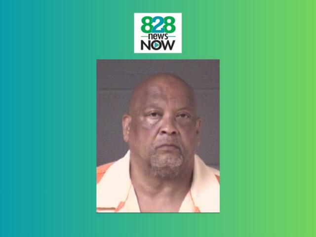 Mugshot portrait of an older man wearing an orange-and-white shirt, set against a gray background with 828 News Now branding above on a teal-green gradient.
