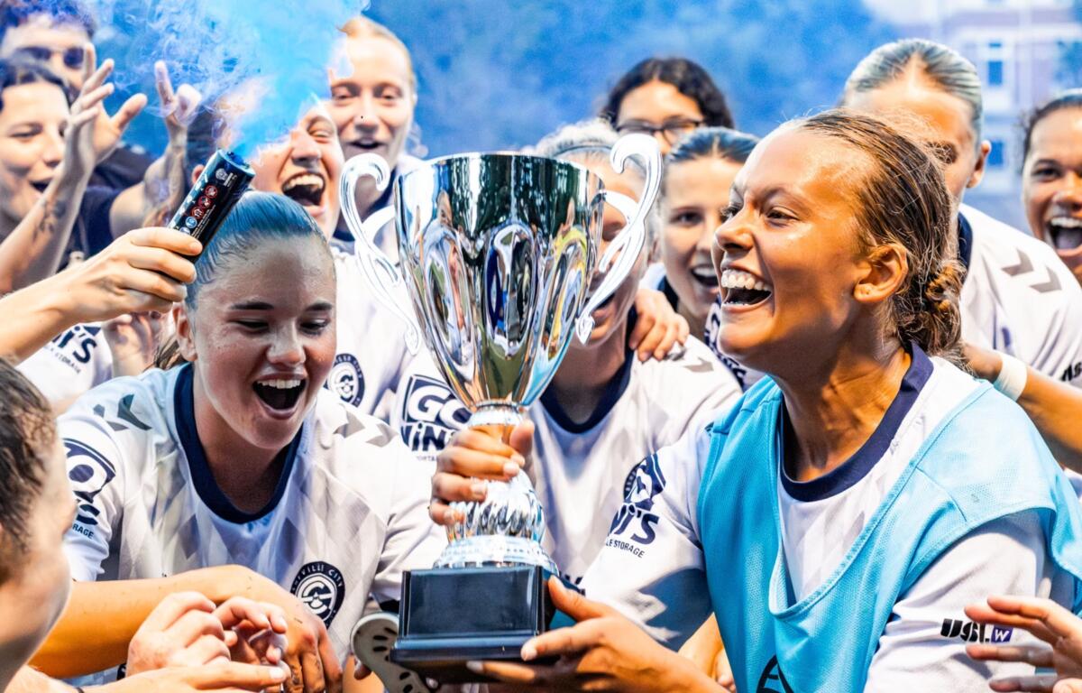 Asheville City SC players celebrate after clinching the South Central Division title with a 2-1 victory over Birmingham Legion WFC, earning a berth in the USL W League playoffs.