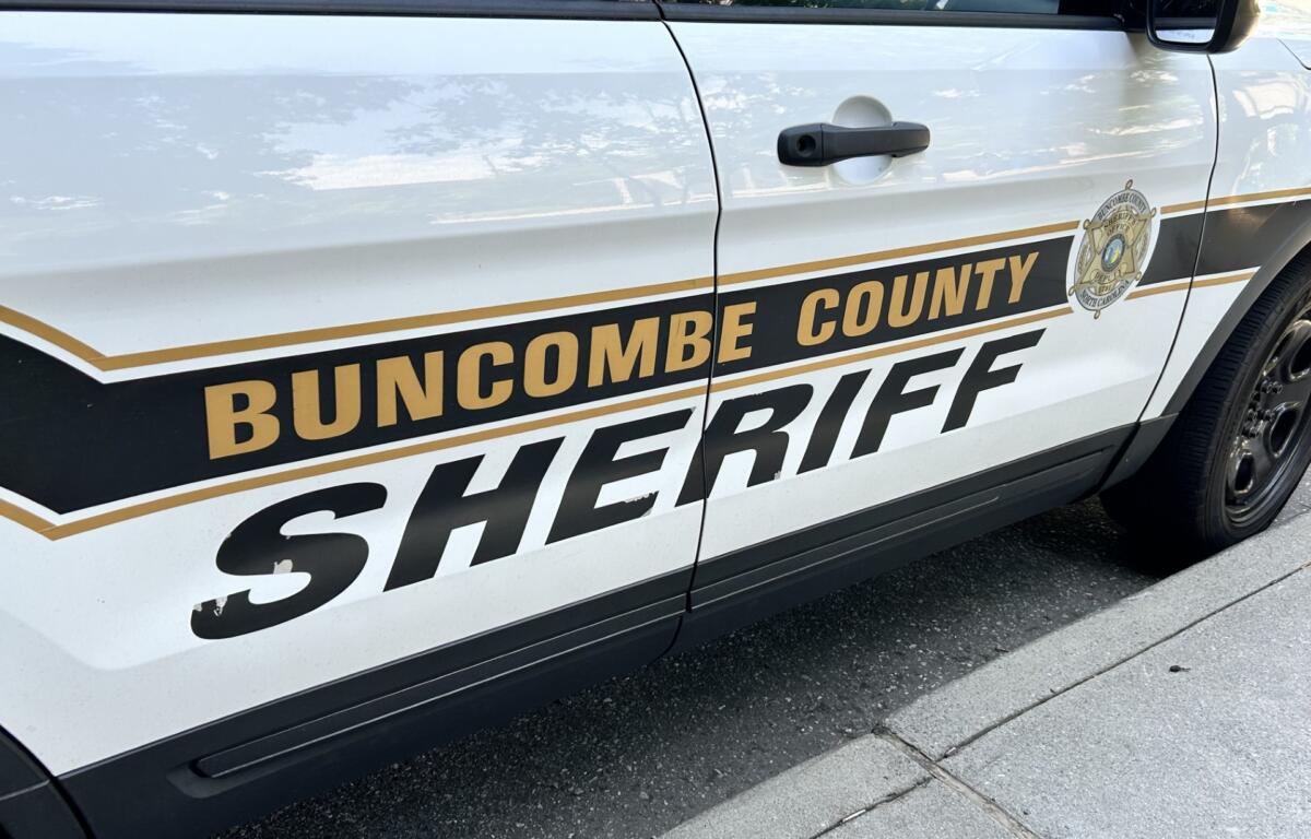 Side view of a Buncombe County Sheriff's Office patrol SUV with emblem and gold stripe on the door edge