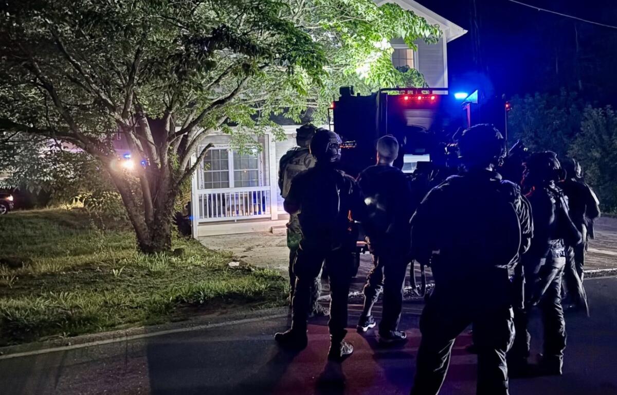 North Carolina SBI's Strategic Swat Unit surrounding the home in Asheville where the two inmates were located.