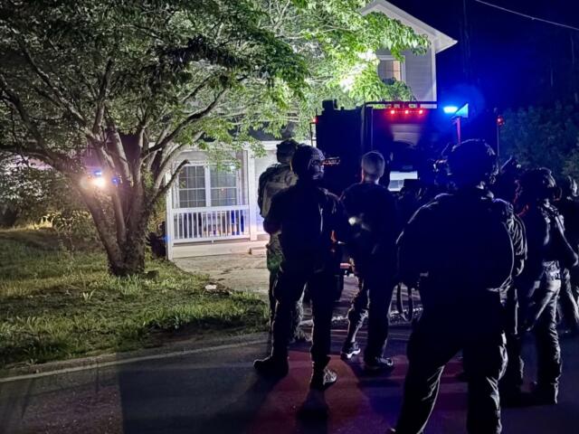 North Carolina SBI's Strategic Swat Unit surrounding the home in Asheville where the two inmates were located.