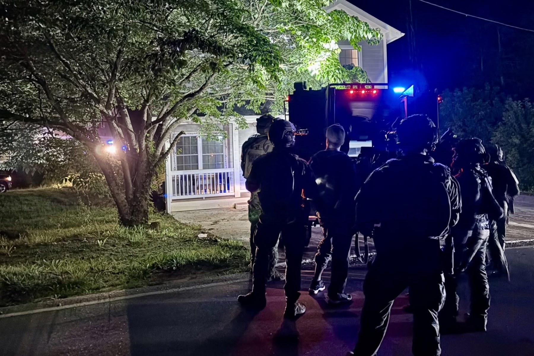 North Carolina SBI's Strategic Swat Unit surrounding the home in Asheville where the two inmates were located.