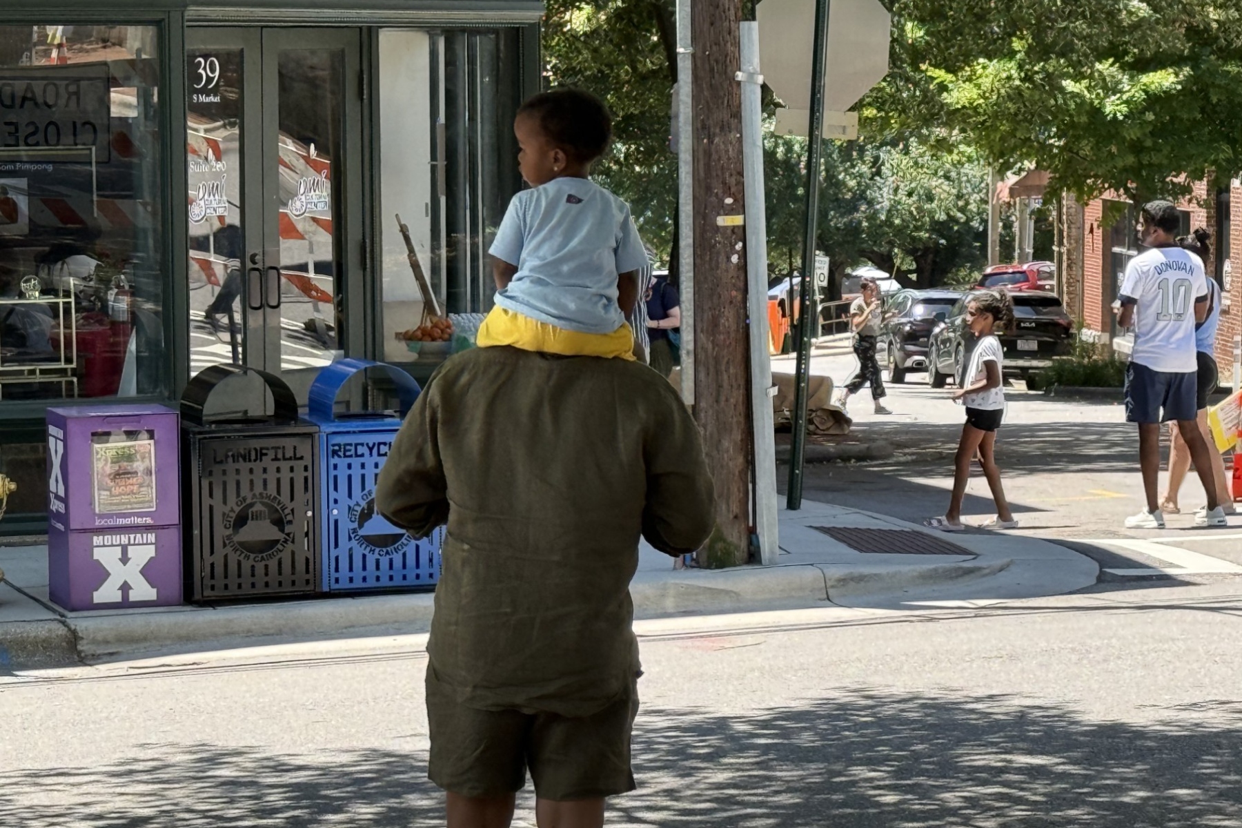 People head to The Block in downtown Asheville as vendors finish setting up for the Juneteenth celebrations taking place Friday.
