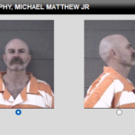 Two mugshots of a bald man with a mustache in an orange jumpsuit, shown from front and side against a gray wall.
