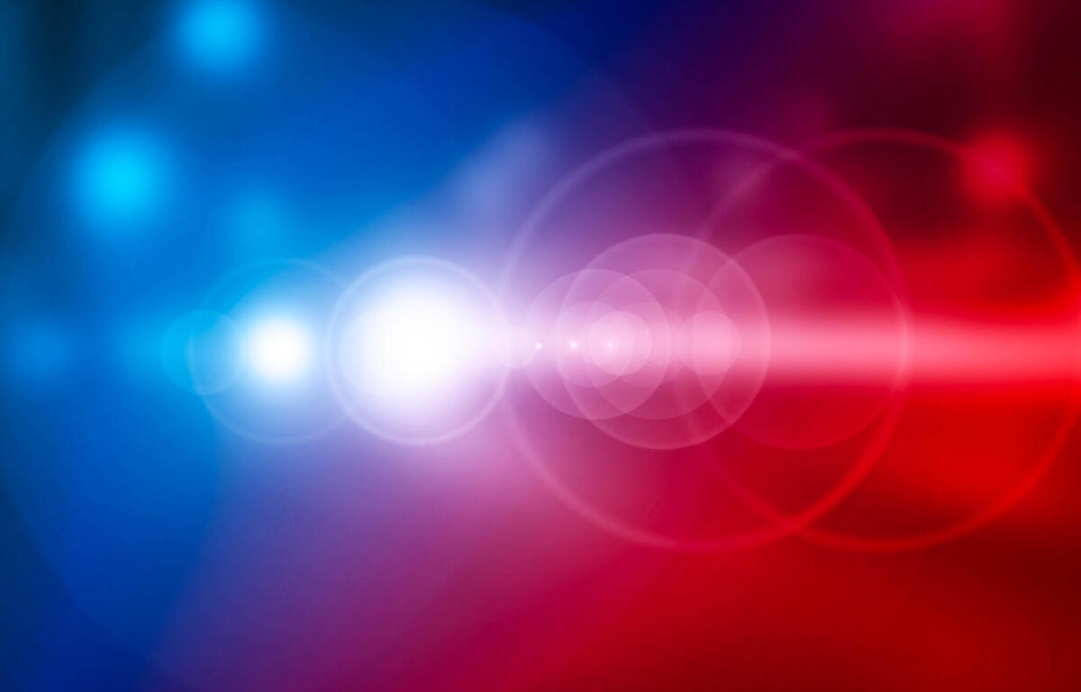 Abstract gradient background transitioning from blue to red with soft white bokeh lights.