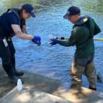 NCDEQ staff collect a water sample from the French Broad River in Asheville as part of the agency's seasonal water quality monitoring program.