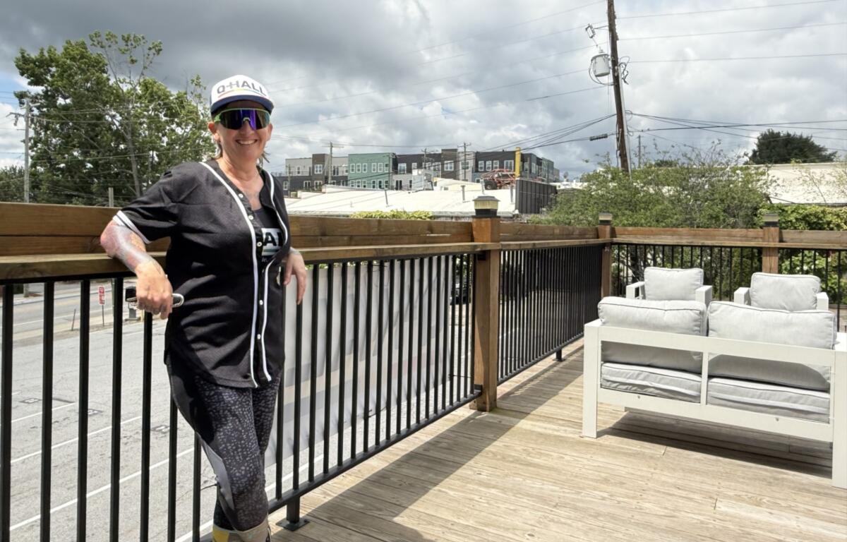 JJ Pope stands on the upstairs deck of the future Q-Hall in downtown Asheville. The venue is set to open later this year as the city’s first women’s sports bar.
