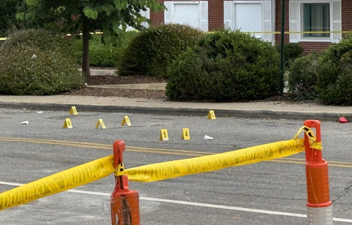 Asheville police officers and forensic investigators process the scene of a deadly shooting along Biltmore Avenue and Short Coxe Avenue early Sunday morning.