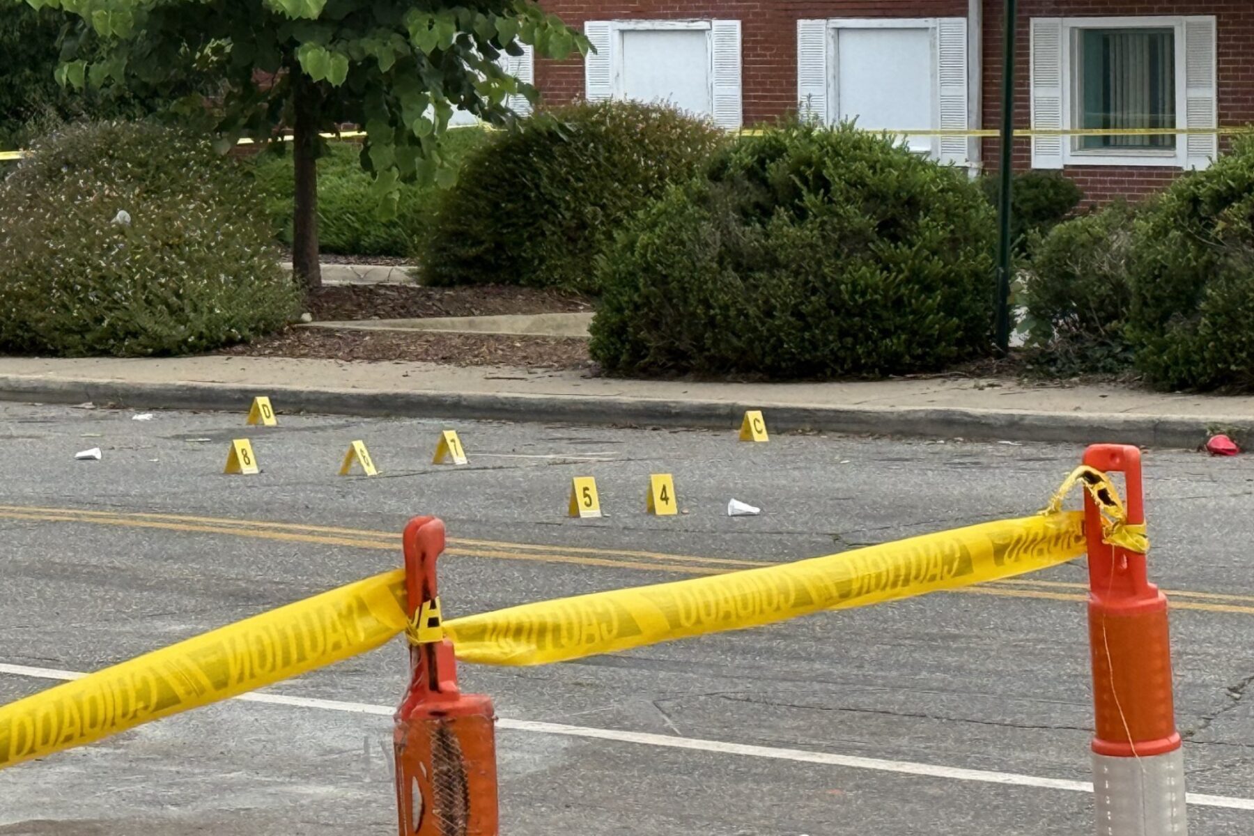 Asheville police officers and forensic investigators process the scene of a deadly shooting along Biltmore Avenue and Short Coxe Avenue early Sunday morning.