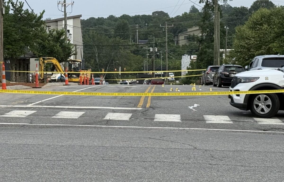 Asheville police officers and forensic investigators process the scene of a deadly shooting along Biltmore Avenue and Short Coxe Avenue early Sunday morning.