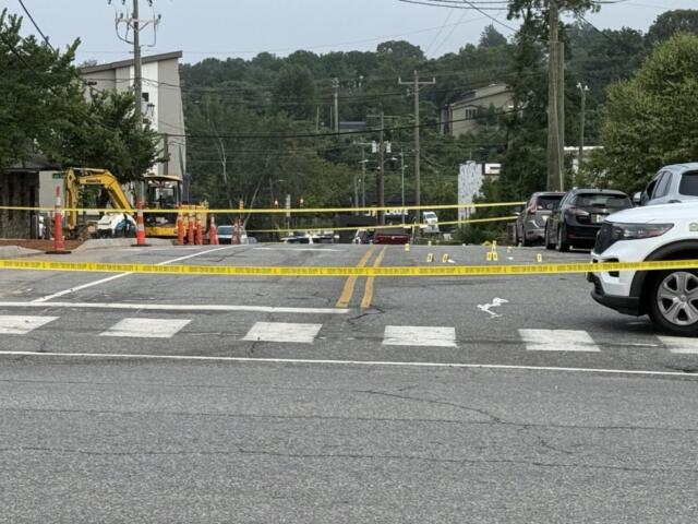 Asheville police officers and forensic investigators process the scene of a deadly shooting along Biltmore Avenue and Short Coxe Avenue early Sunday morning.