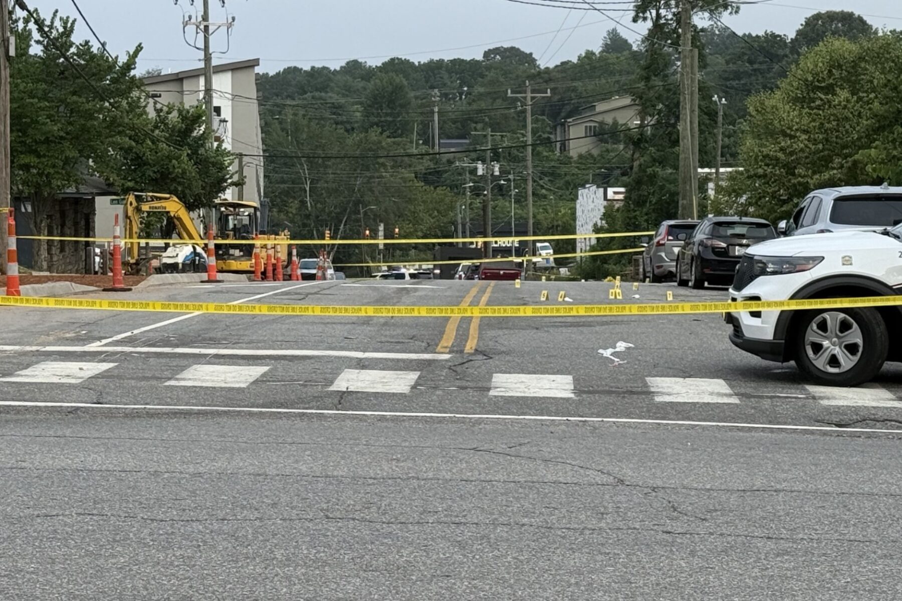 Asheville police officers and forensic investigators process the scene of a deadly shooting along Biltmore Avenue and Short Coxe Avenue early Sunday morning.