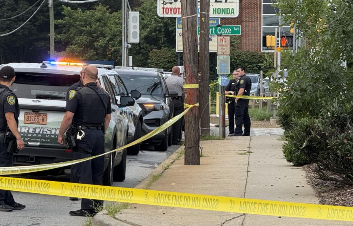 Asheville police officers and forensic investigators process the scene of a deadly shooting along Biltmore Avenue and Short Coxe Avenue early Sunday morning.