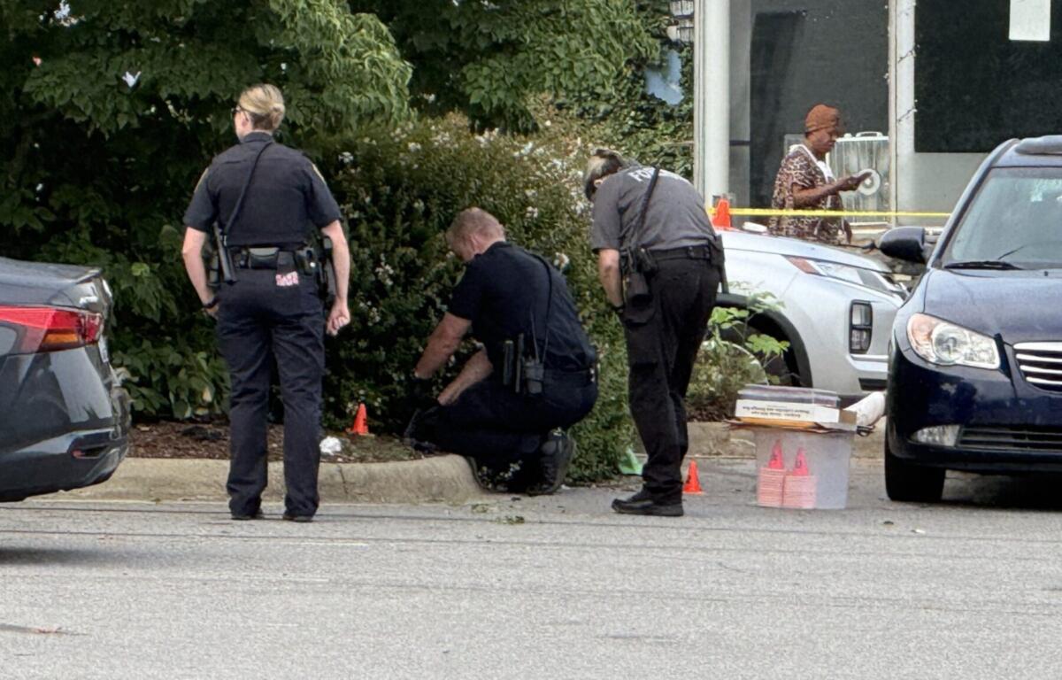 Asheville police officers and forensic investigators process the scene of a deadly shooting along Biltmore Avenue and Short Coxe Avenue early Sunday morning.