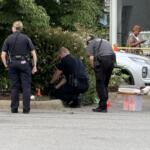 Asheville police officers and forensic investigators process the scene of a deadly shooting along Biltmore Avenue and Short Coxe Avenue early Sunday morning.