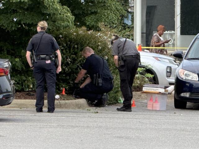 Asheville police officers and forensic investigators process the scene of a deadly shooting along Biltmore Avenue and Short Coxe Avenue early Sunday morning.