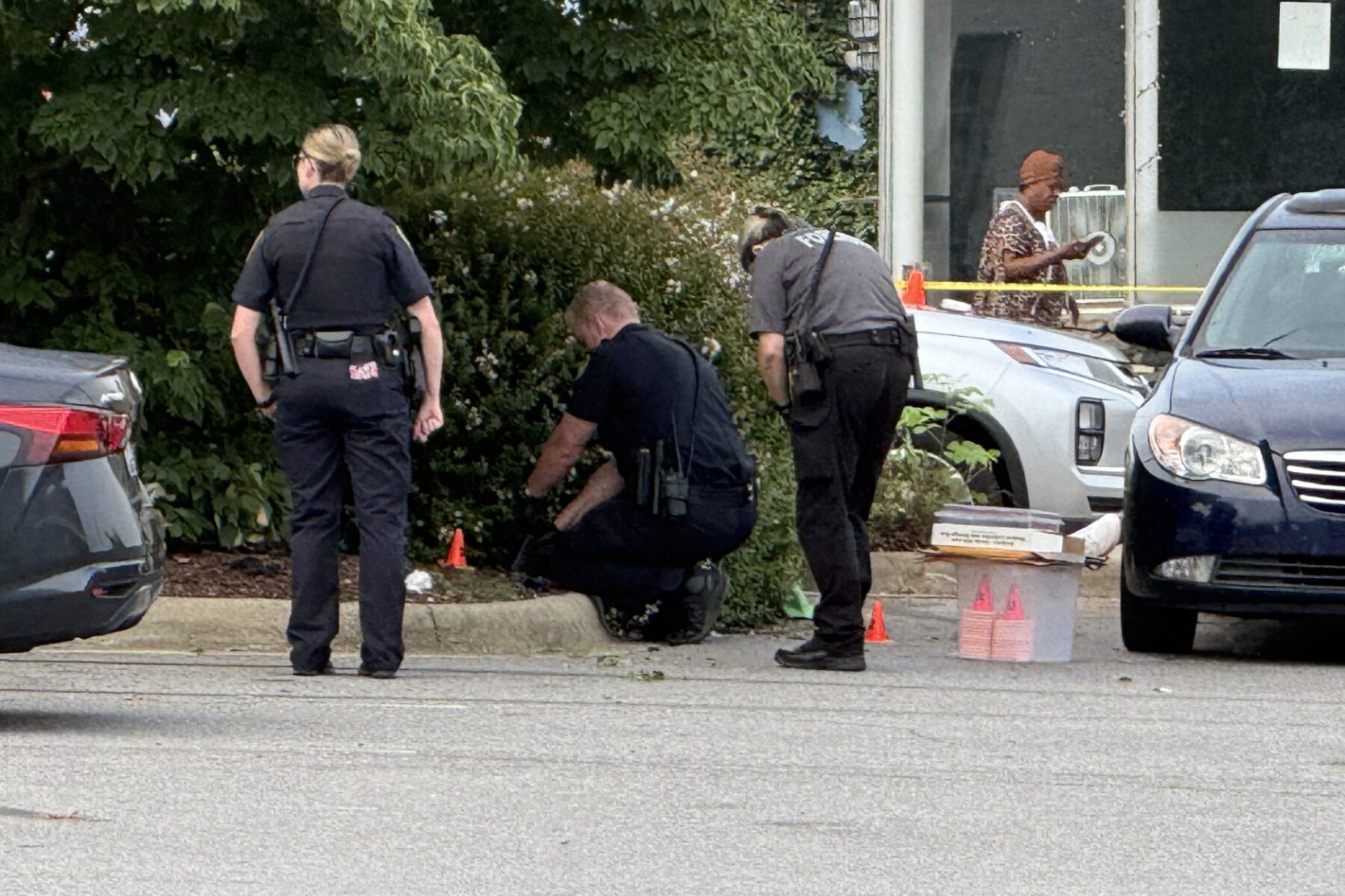 Asheville police officers and forensic investigators process the scene of a deadly shooting along Biltmore Avenue and Short Coxe Avenue early Sunday morning.
