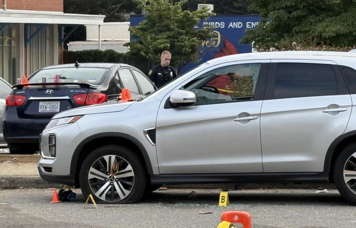 Asheville police officers and forensic investigators process the scene of a deadly shooting along Biltmore Avenue and Short Coxe Avenue early Sunday morning.