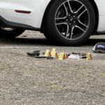 Evidence markers are placed in the parking lot of a business on North French Broad Avenue in downtown Asheville following an early Wednesday officer-involved shooting.