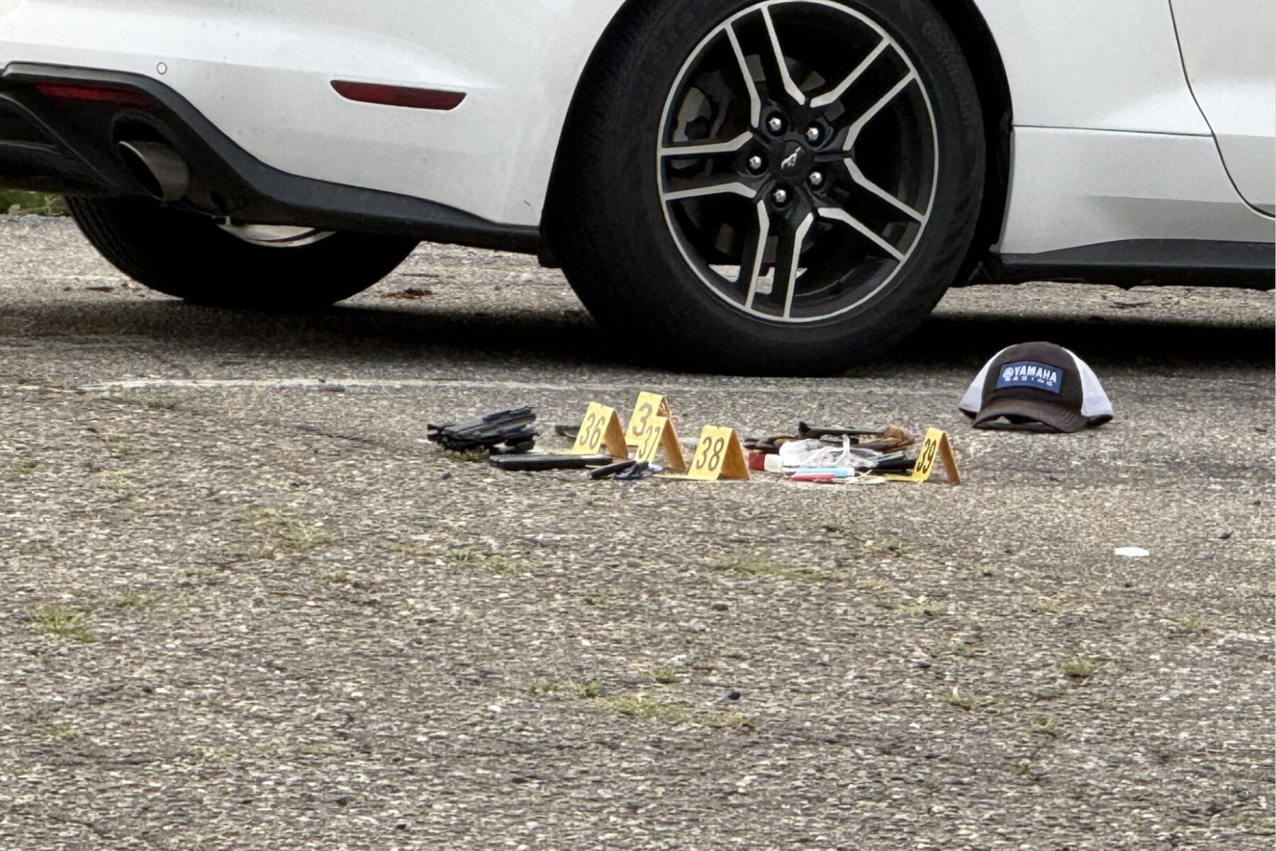 Evidence markers are placed in the parking lot of a business on North French Broad Avenue in downtown Asheville following an early Wednesday officer-involved shooting.