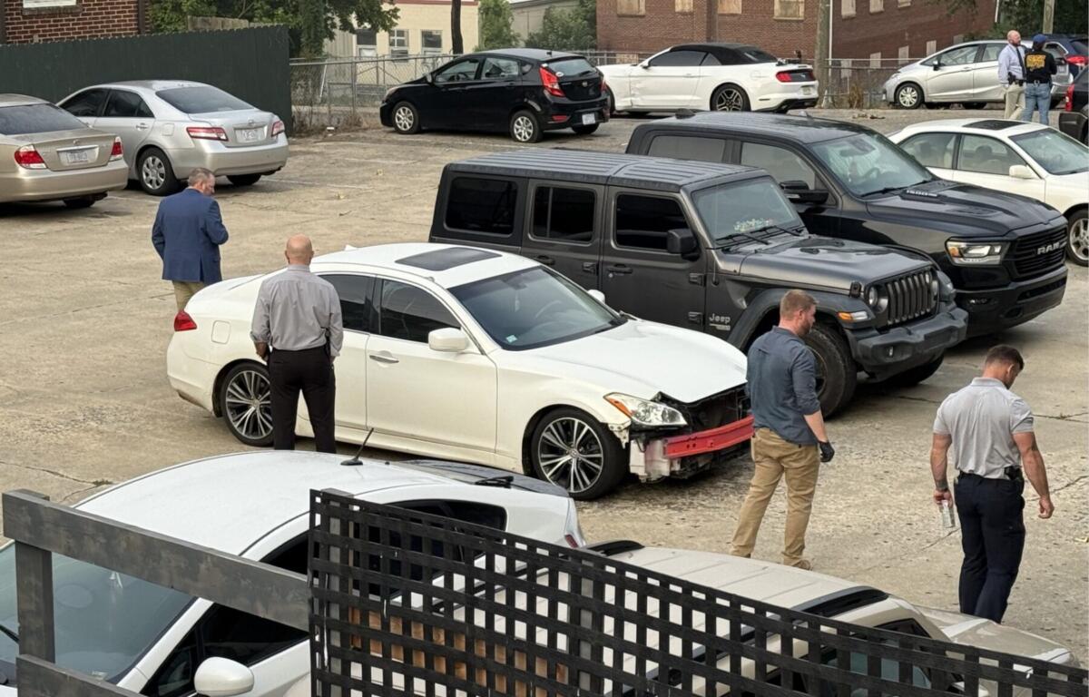 North Carolina State Bureau of Investigation agents process the scene of an officer-involved shooting on North French Broad Avenue in downtown Asheville early Wednesday.