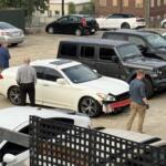 North Carolina State Bureau of Investigation agents process the scene of an officer-involved shooting on North French Broad Avenue in downtown Asheville early Wednesday.