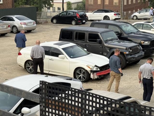 North Carolina State Bureau of Investigation agents process the scene of an officer-involved shooting on North French Broad Avenue in downtown Asheville early Wednesday.