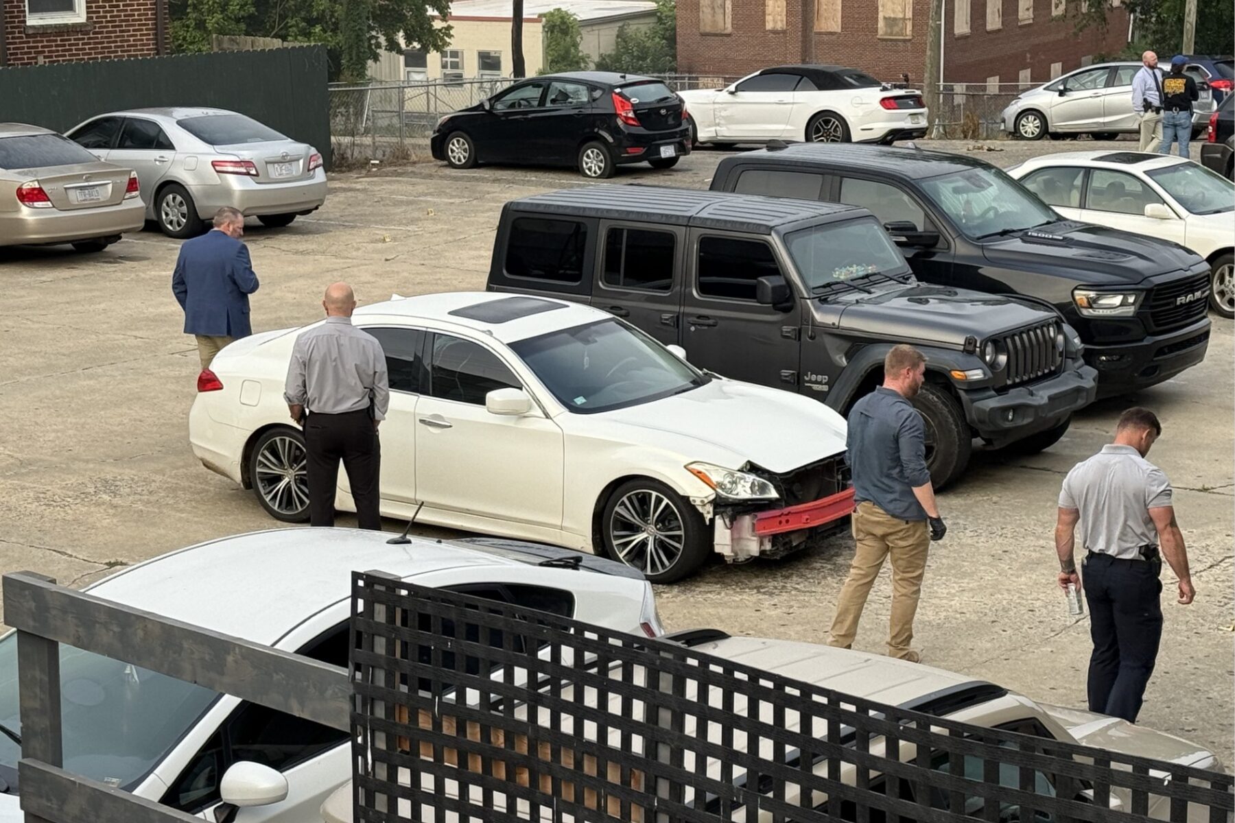 North Carolina State Bureau of Investigation agents process the scene of an officer-involved shooting on North French Broad Avenue in downtown Asheville early Wednesday.
