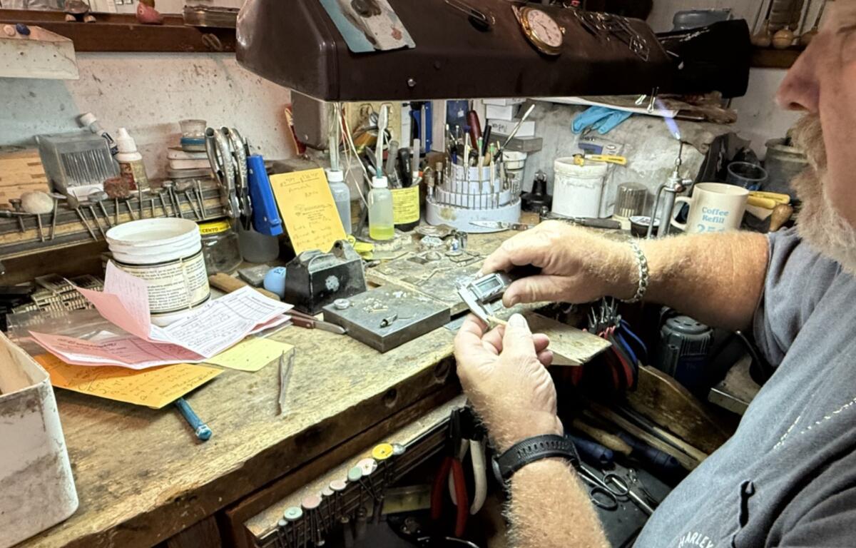 A jeweler at D.C. Creasman Jewelers crafts a custom wedding band using gold provided by the customer.