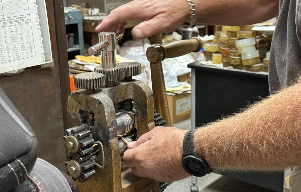 A jeweler at D.C. Creasman Jewelers crafts a custom wedding band using gold provided by the customer.