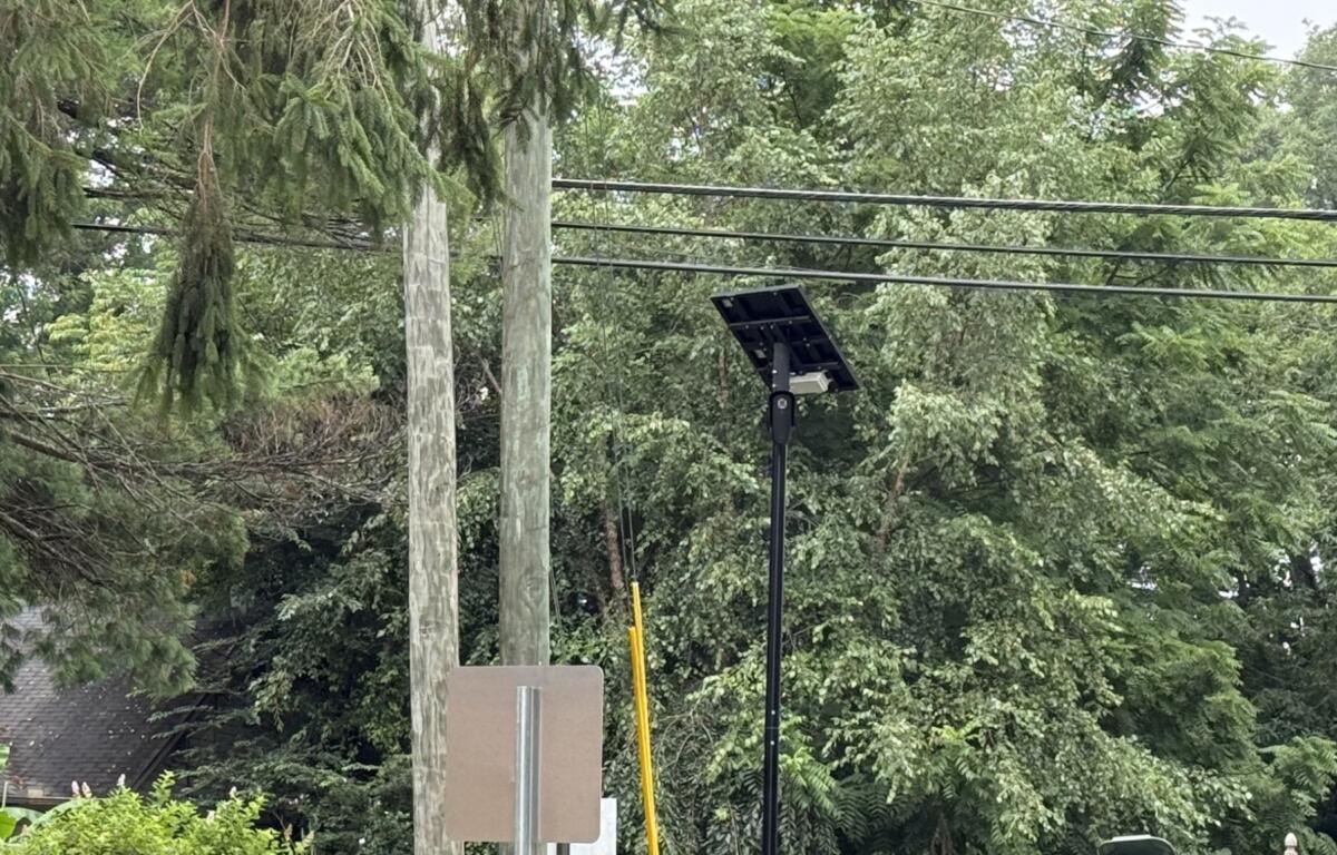 A Flock automated license plate reader camera is seen at the entrance/exit of Deaverview Apartments in Asheville.