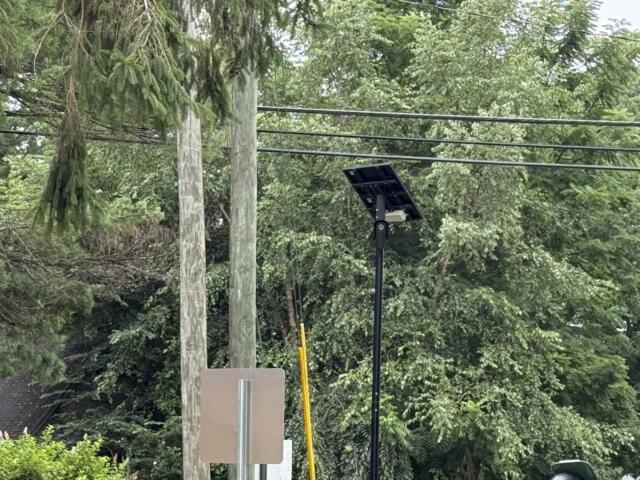 A Flock automated license plate reader camera is seen at the entrance/exit of Deaverview Apartments in Asheville.