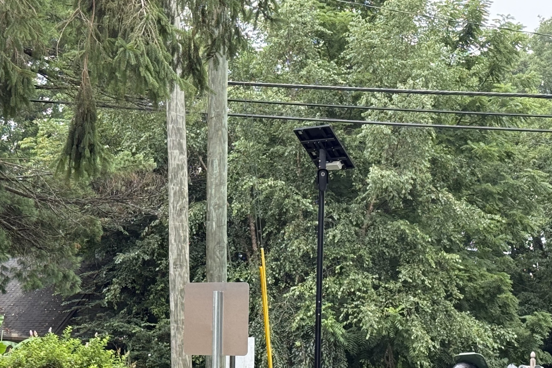 A Flock automated license plate reader camera is seen at the entrance/exit of Deaverview Apartments in Asheville.