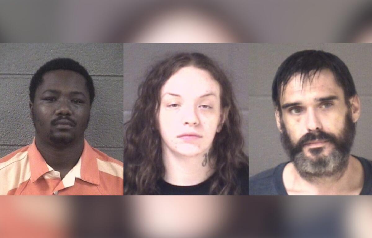 Three mugshots of suspects against gray walls, shown left to right: a Black man in an orange striped prison uniform, a white woman with curly hair and a neck tattoo, and a bearded man with dark hair.
