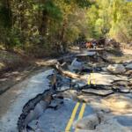 A section of Green River Cove Road in Polk County remains heavily damaged following Tropical Storm Helene, with washouts and slope failures visible along the roadway as crews begin long-term reconstruction efforts.