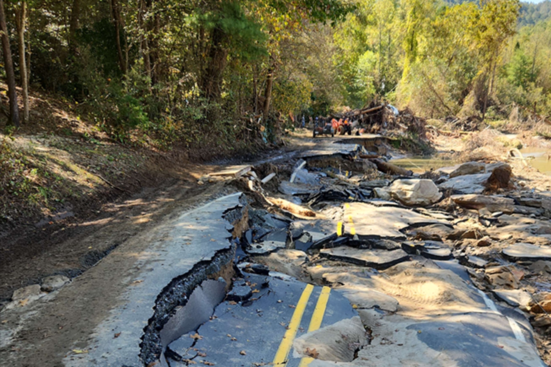 A section of Green River Cove Road in Polk County remains heavily damaged following Tropical Storm Helene, with washouts and slope failures visible along the roadway as crews begin long-term reconstruction efforts.