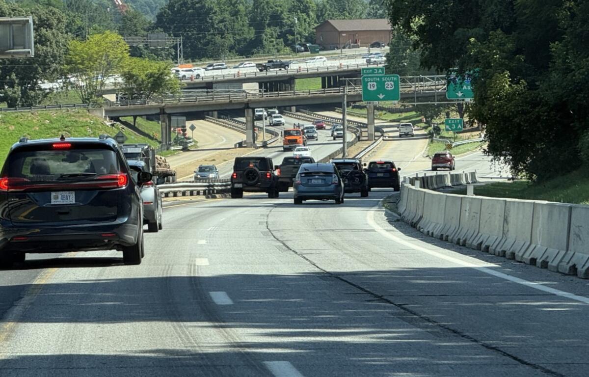 Traffic moves through the I-26 Connector construction zone in Asheville as crews continue preparing the corridor for upcoming bridge work, utility relocations and other major improvements.