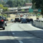 Traffic moves through the I-26 Connector construction zone in Asheville as crews continue preparing the corridor for upcoming bridge work, utility relocations and other major improvements.