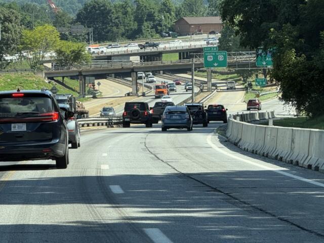 Traffic moves through the I-26 Connector construction zone in Asheville as crews continue preparing the corridor for upcoming bridge work, utility relocations and other major improvements.