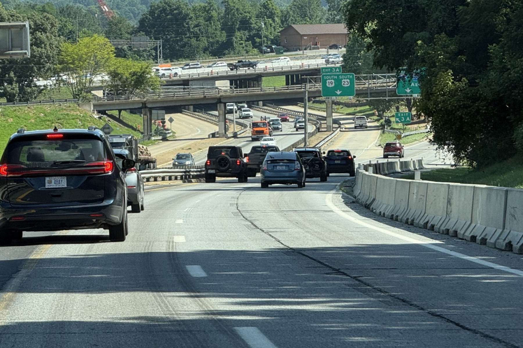 Traffic moves through the I-26 Connector construction zone in Asheville as crews continue preparing the corridor for upcoming bridge work, utility relocations and other major improvements.