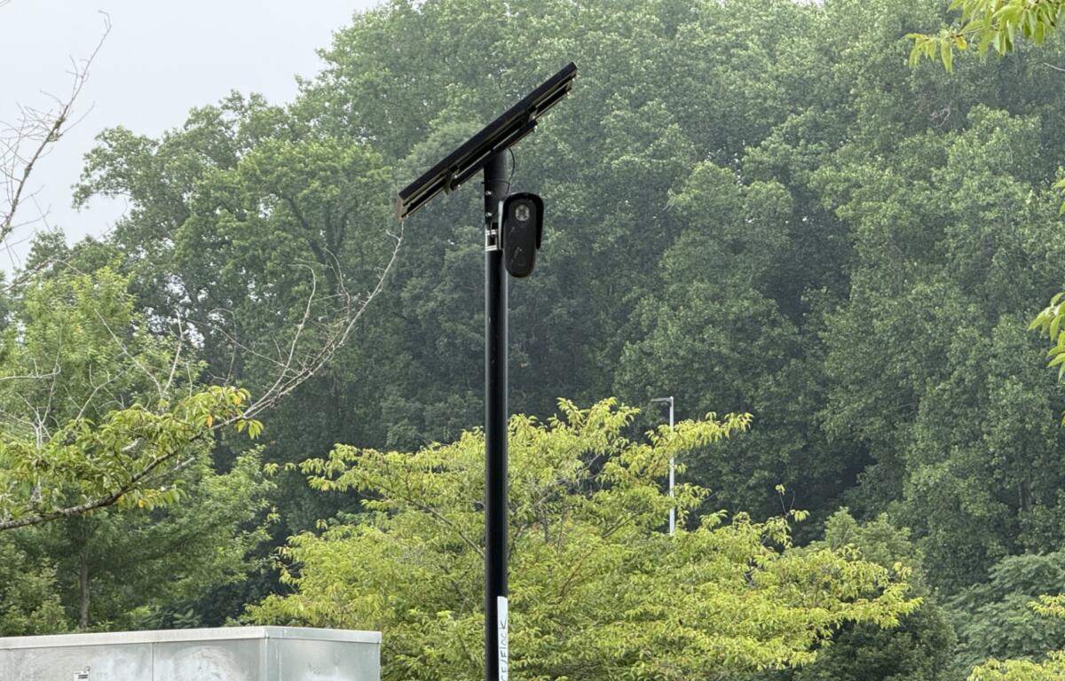 A Flock automated license plate reader camera is seen at the entrance/exit of Lowe's of Smokey Park Highway in Asheville.