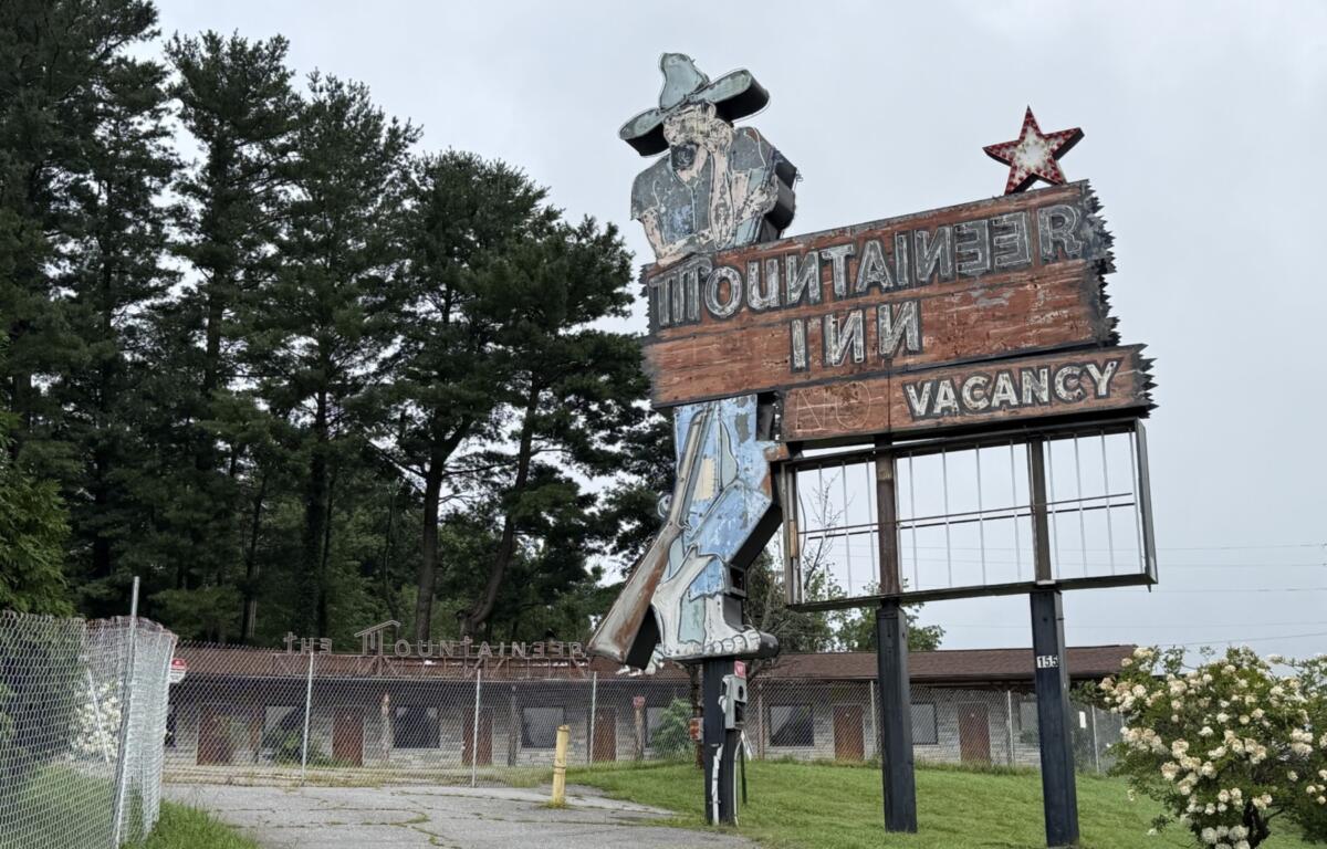 The fenced-off Mountaineer Inn property at 155 Tunnel Road sits vacant in Asheville. City planning records show a preliminary proposal for a Sheetz convenience store and gas station at the longtime motel site, though the project remains in the early review process.
