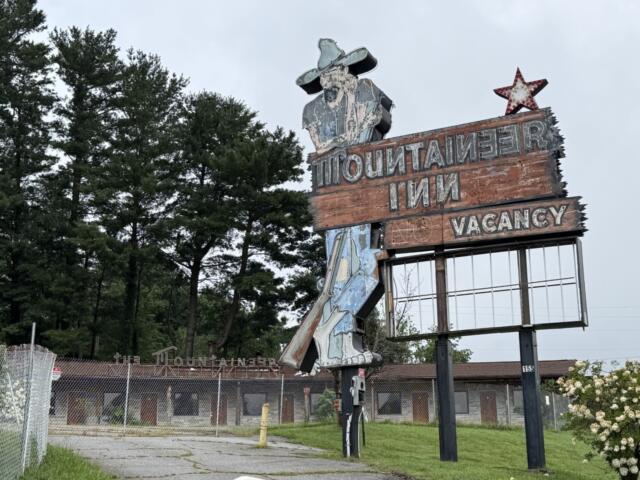 The fenced-off Mountaineer Inn property at 155 Tunnel Road sits vacant in Asheville. City planning records show a preliminary proposal for a Sheetz convenience store and gas station at the longtime motel site, though the project remains in the early review process.